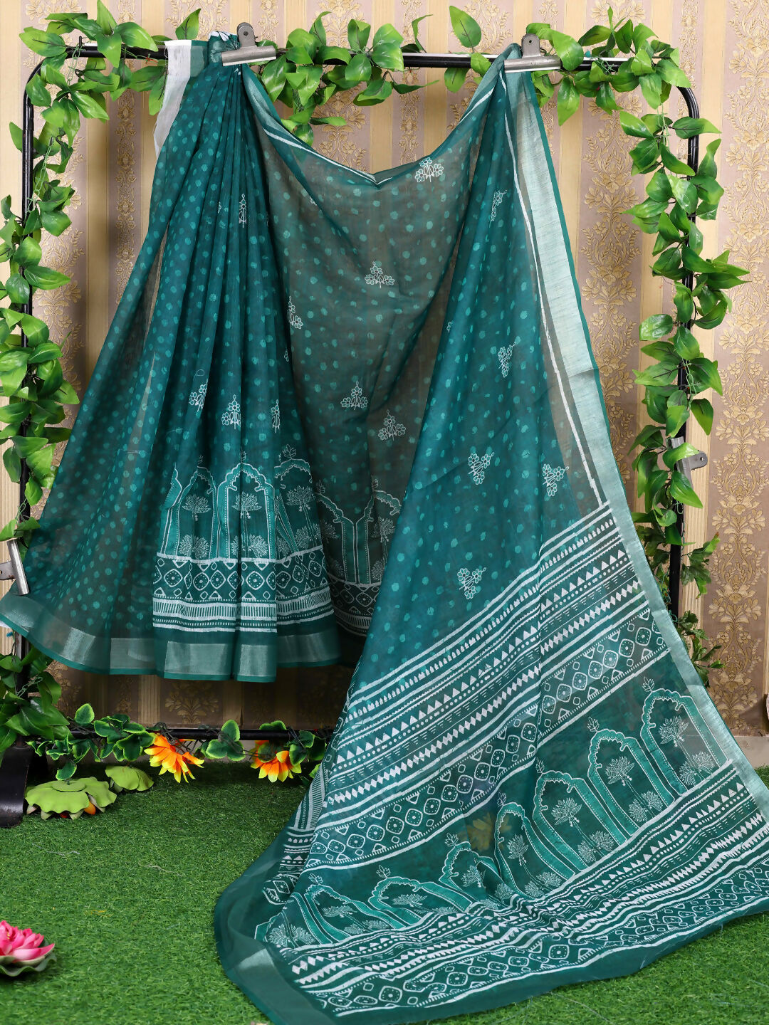 A elegant teal cotton saree with matching blouse, featuring a comfortable and breathable design.