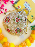 White and gold geometric patterned potli bag with drawstring closure for women.