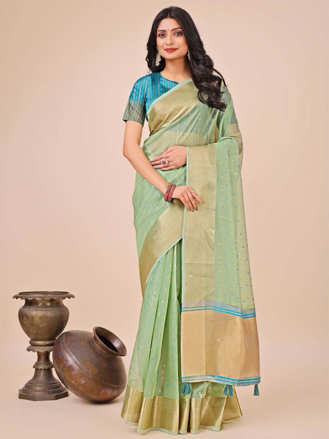 Elegant Green Organza Saree with matching blouse fabric.