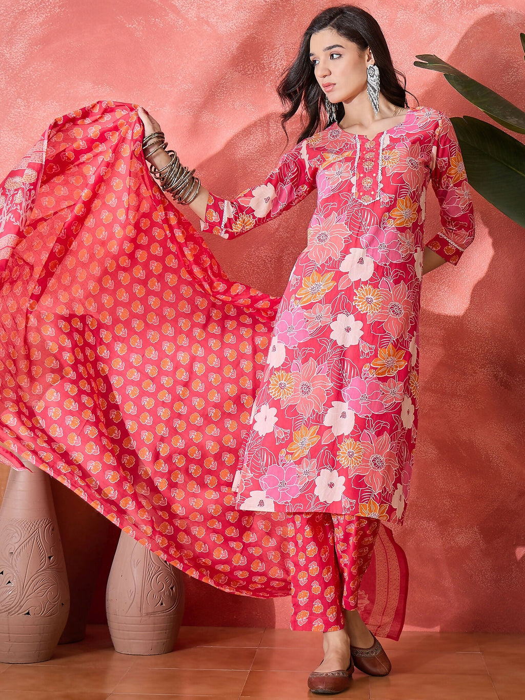 Woman wearing a stylish pink printed pure cotton kurta set with a graceful aesthetic
