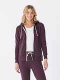 Women wearing a dark purple triblend fleece zip-up hoodie with a sporty aesthetic.