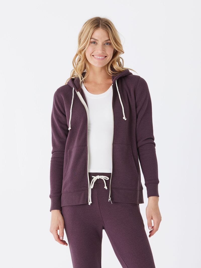Women wearing a dark purple triblend fleece zip-up hoodie with a sporty aesthetic.