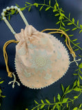 Peach potli bag featuring intricate pearl hand work for wedding and festive wear