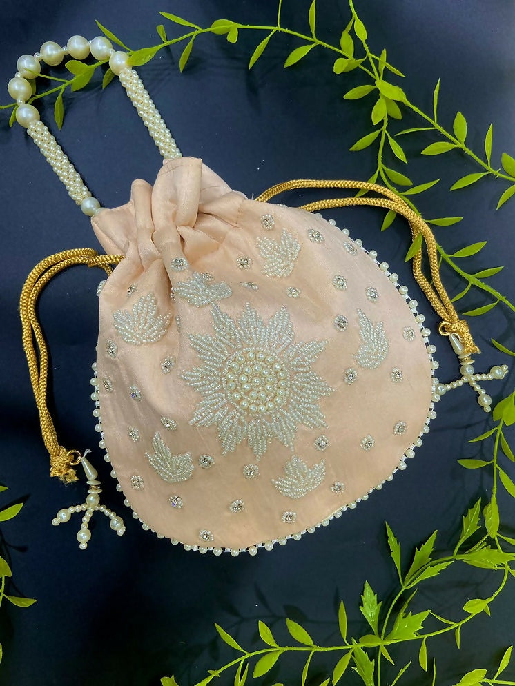 Peach potli bag featuring intricate pearl hand work for wedding and festive wear
