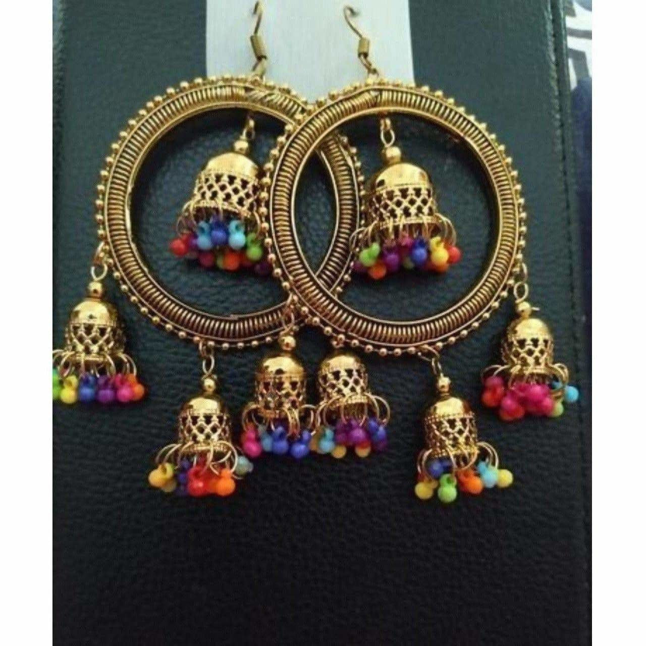 Traditional gold-polished jhumka earrings with pearl latkan detailing for weddings.