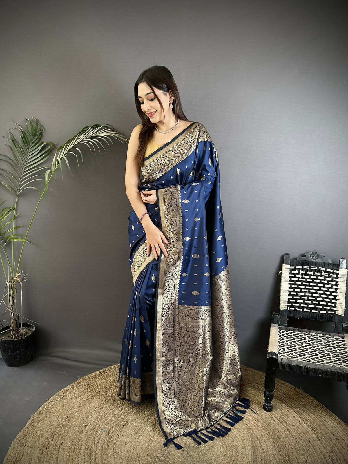 Navy blue Lichi Silk Banarasi saree featuring elegant gold zari weaving motifs and matching blouse fabric