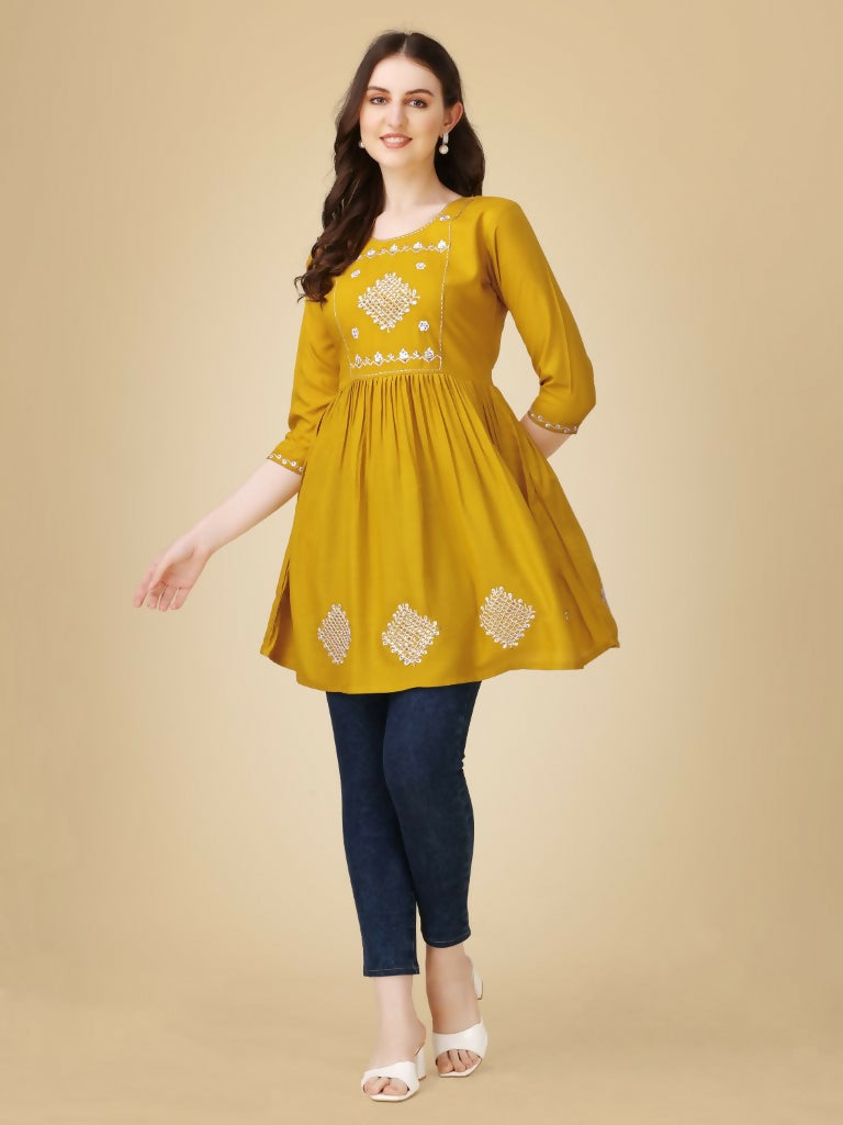 Mustard yellow women's casual top with detailed embroidery and sequence work on viscose rayon.