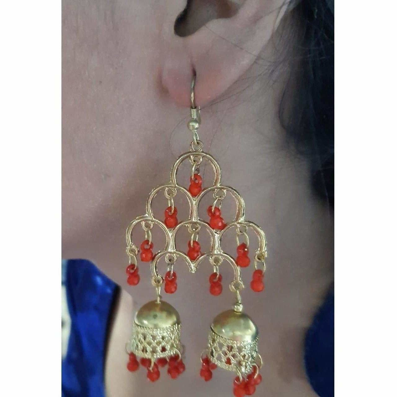 Gold-polished double jhumka earrings featuring red pearls