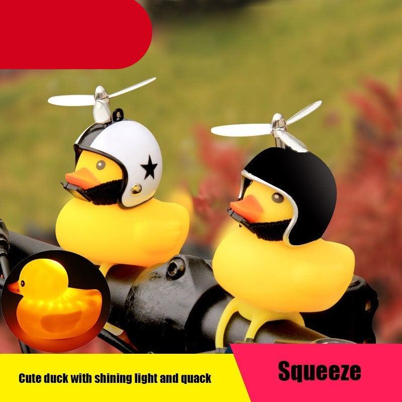 Yellow rubber duck bike bell with a propeller helmet, sunglasses, and gold chain for kids' bicycles.