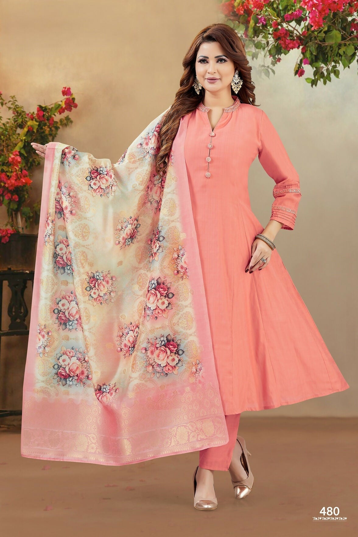 Peach colored soft silk kurta set featuring intricate embroidery details