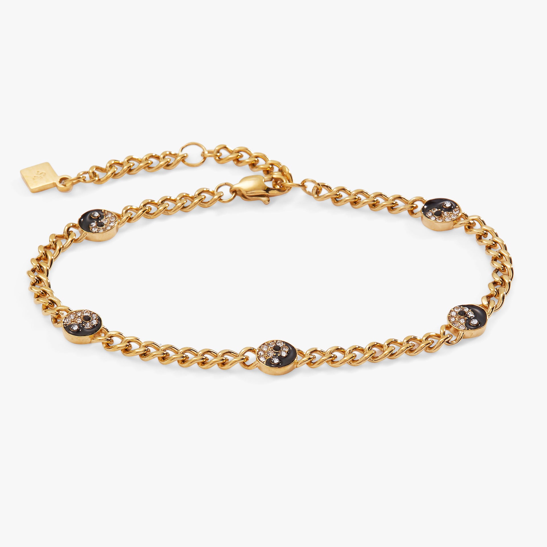 Gold curb chain bracelet featuring five yin yang charms with clear crystals and black enamel.