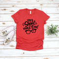 Heather red unisex t-shirt with black graphic text that reads You'll Shoot Your Eye Out and an illustration of glasses