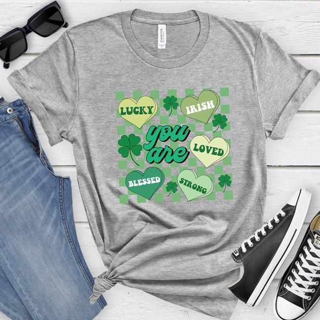 Shamrock hearts graphic design featuring lucky, irish, blessed, and strong text on an athletic heather grey t-shirt or sweatshirt