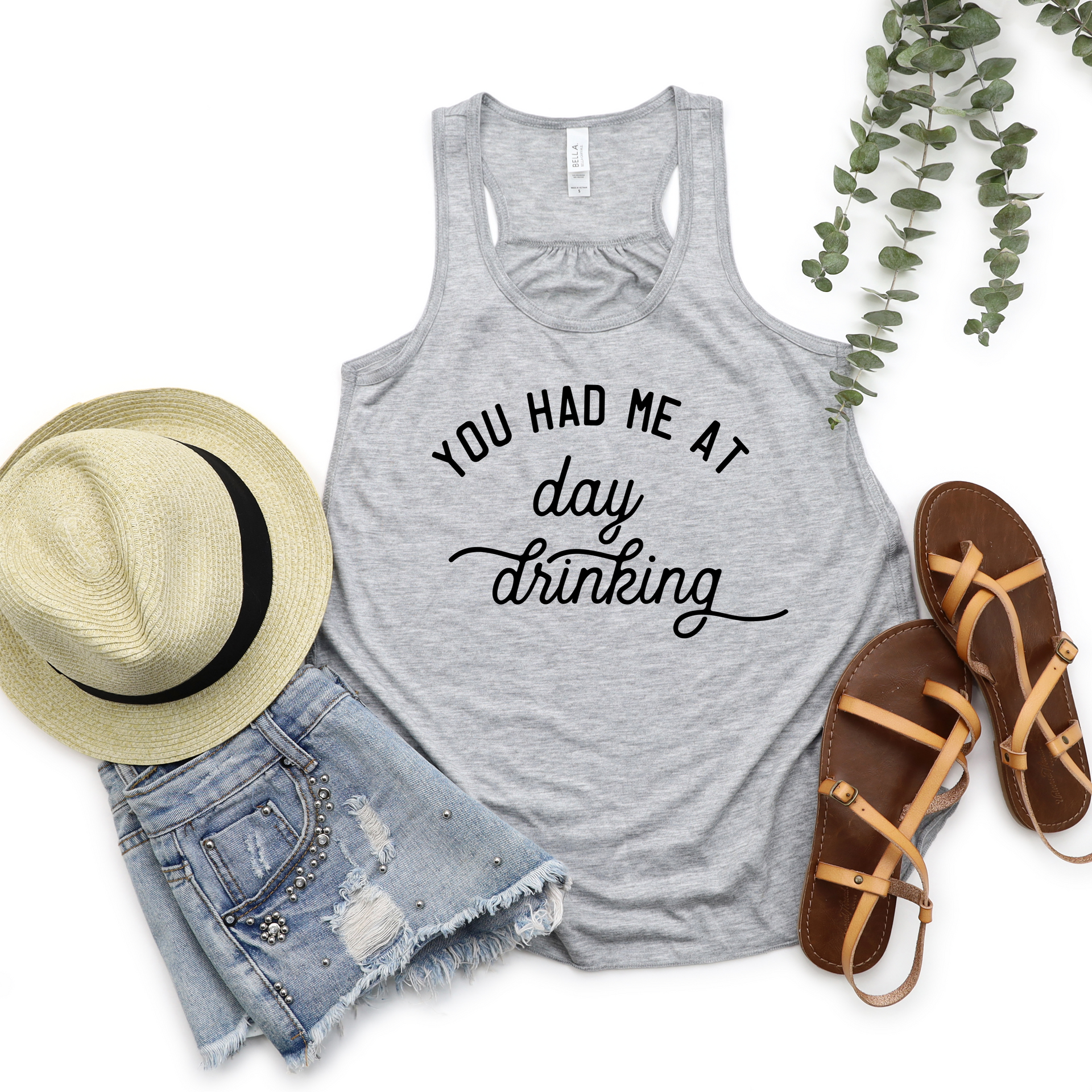 Athletic heather gray racerback tank top with You Had Me At Day Drinking slogan, styled with a hat and sandals