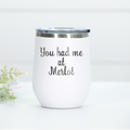White stainless steel wine tumbler with the phrase 'You had me at Merlot' laser engraved on the front, featuring a clear lid.