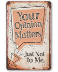 A rustic metal sign featuring the text Your Opinion Matters Just Not to Me with a megaphone graphic