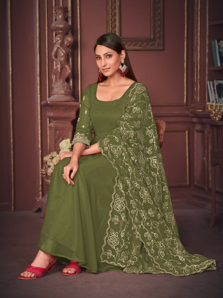 Woman wearing an elegant floor-length olive green georgette embroidered Anarkali kurta pant set with a dupatta.