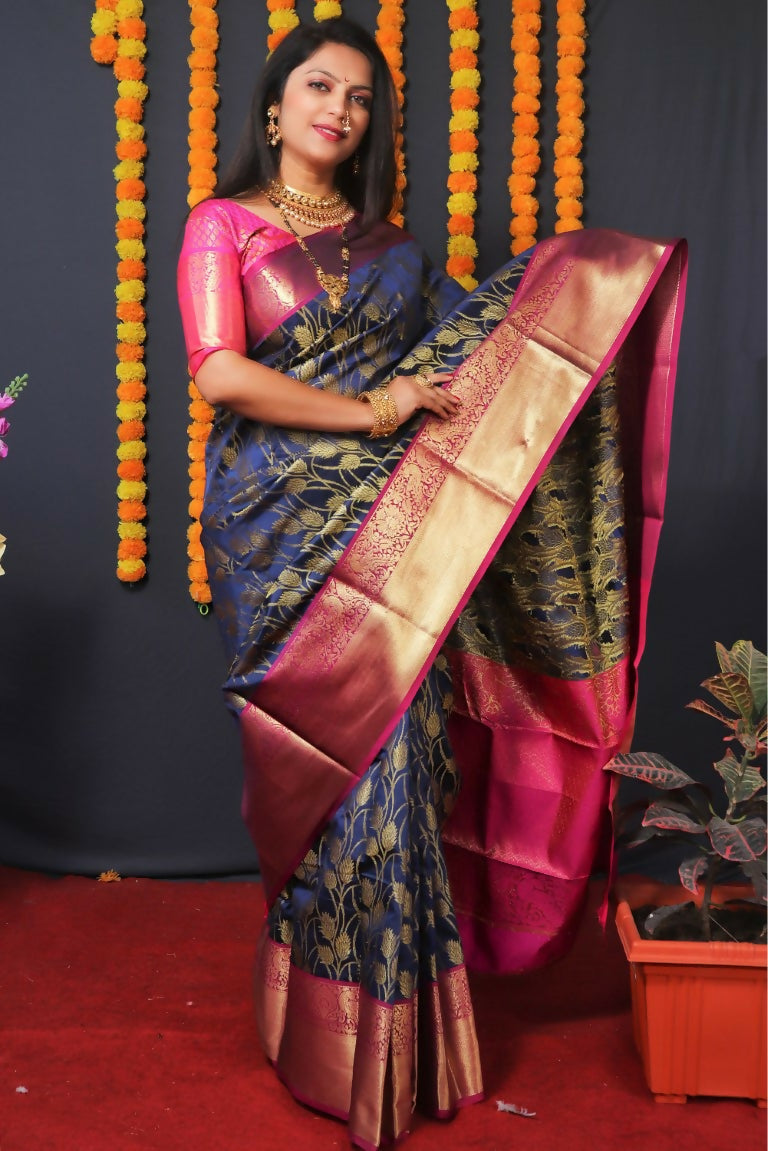 Navy blue Kanjivaram silk saree with gold Zari weaving and a contrasting pink blouse.