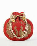 Red embroidered potli clutch bag featuring intricate traditional designs