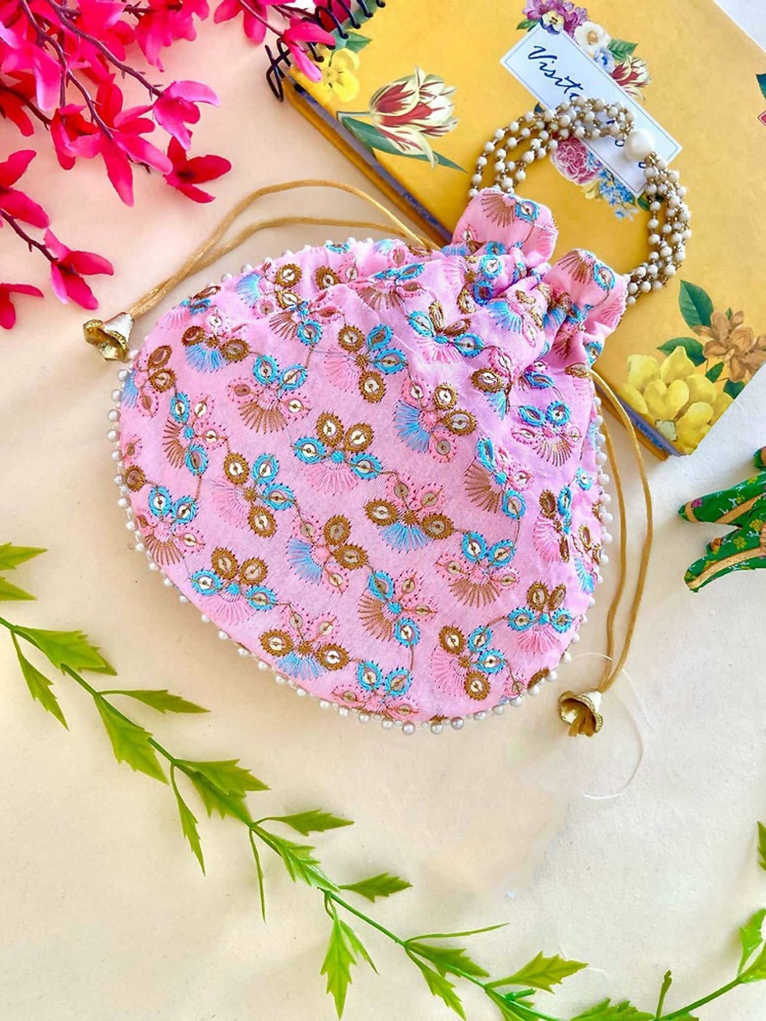 Vibrant pink handcrafted potli bag ideal for wedding guest outfits