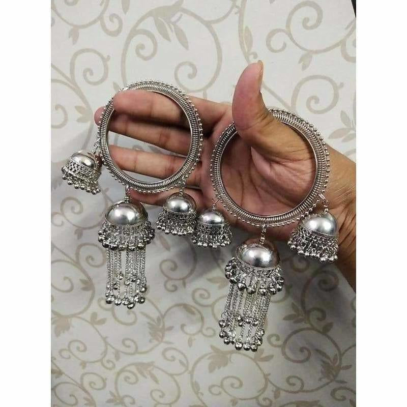 Modern silver-tone bangle with an oversized hanging jhumka charm