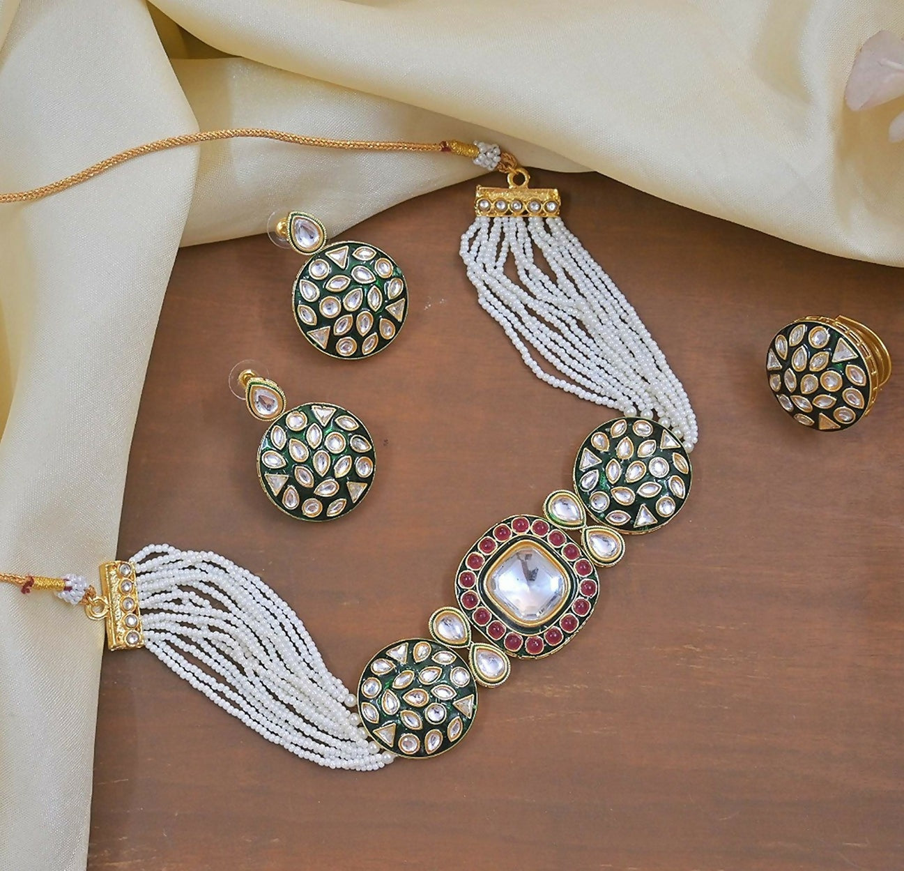 Bottle green Meenakari Kundan pearl choker set with gold-plated geometric detailing and a tie closure.