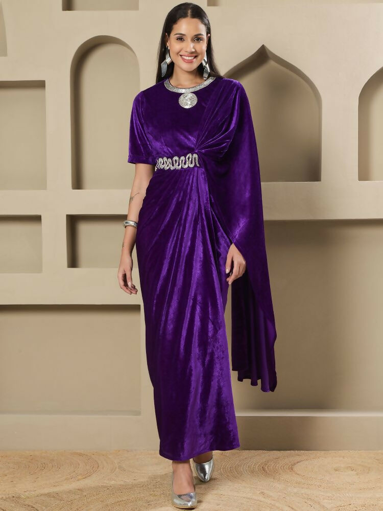 Woman wearing a purple velvet stitched dress with intricate hand-embellished details.