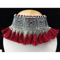 Close-up view of a modern maroon and silver oxidized necklace with intricate thread work