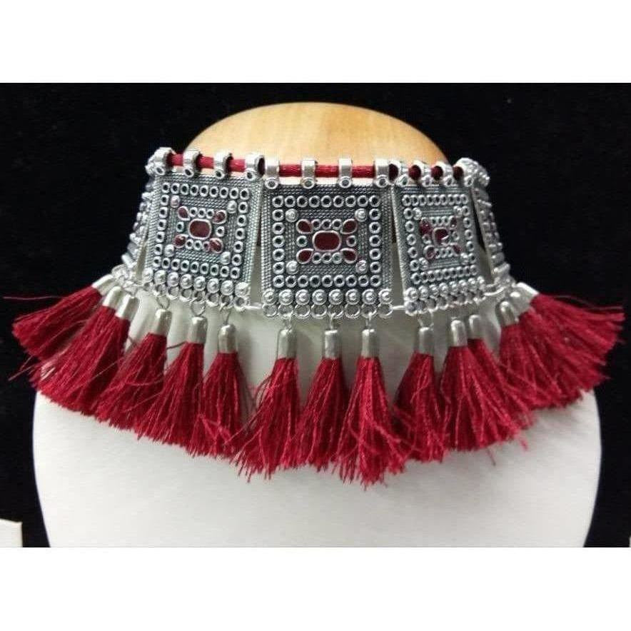 Close-up view of a modern maroon and silver oxidized necklace with intricate thread work