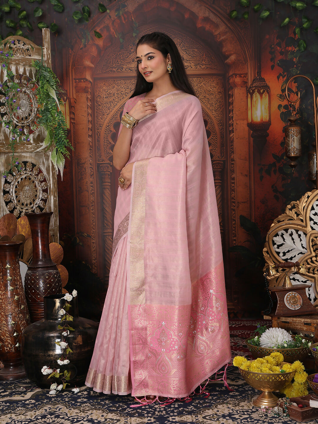 Stunning light pink organza saree with matching blouse, featuring a sheer and elegant finish.