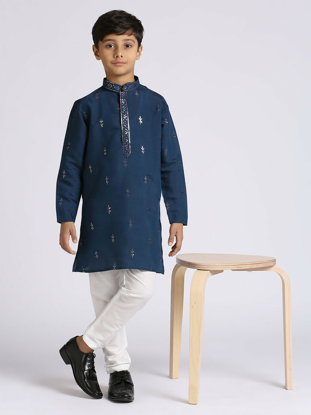 Boy in a festive blue silk kurta with embroidery detailing