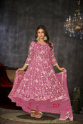 Woman wearing a pink embroidered net Anarkali kurta set with dupatta