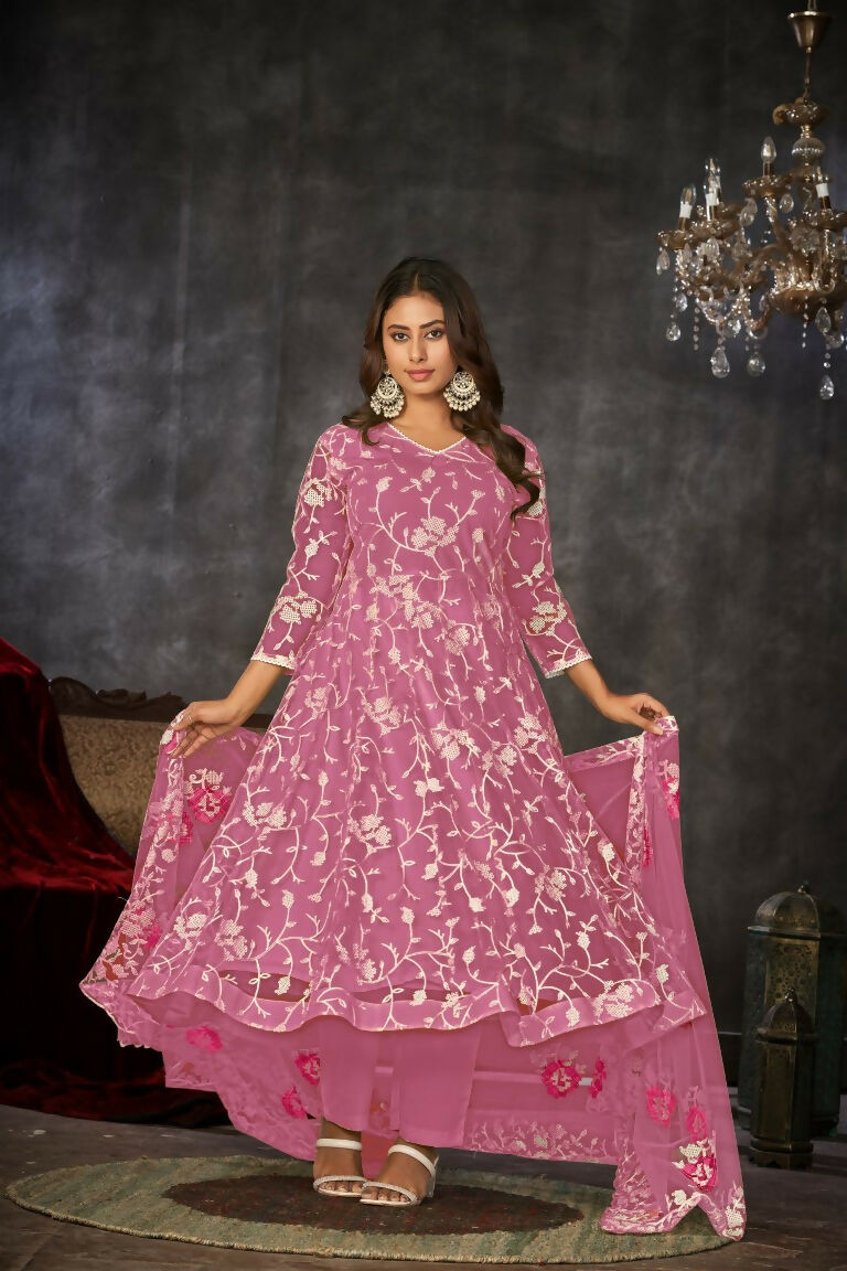 Woman wearing a pink embroidered net Anarkali kurta set with dupatta
