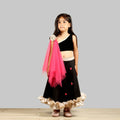 One-shoulder black scuba ghagra choli with gold frill hem and pink floral net dupatta.