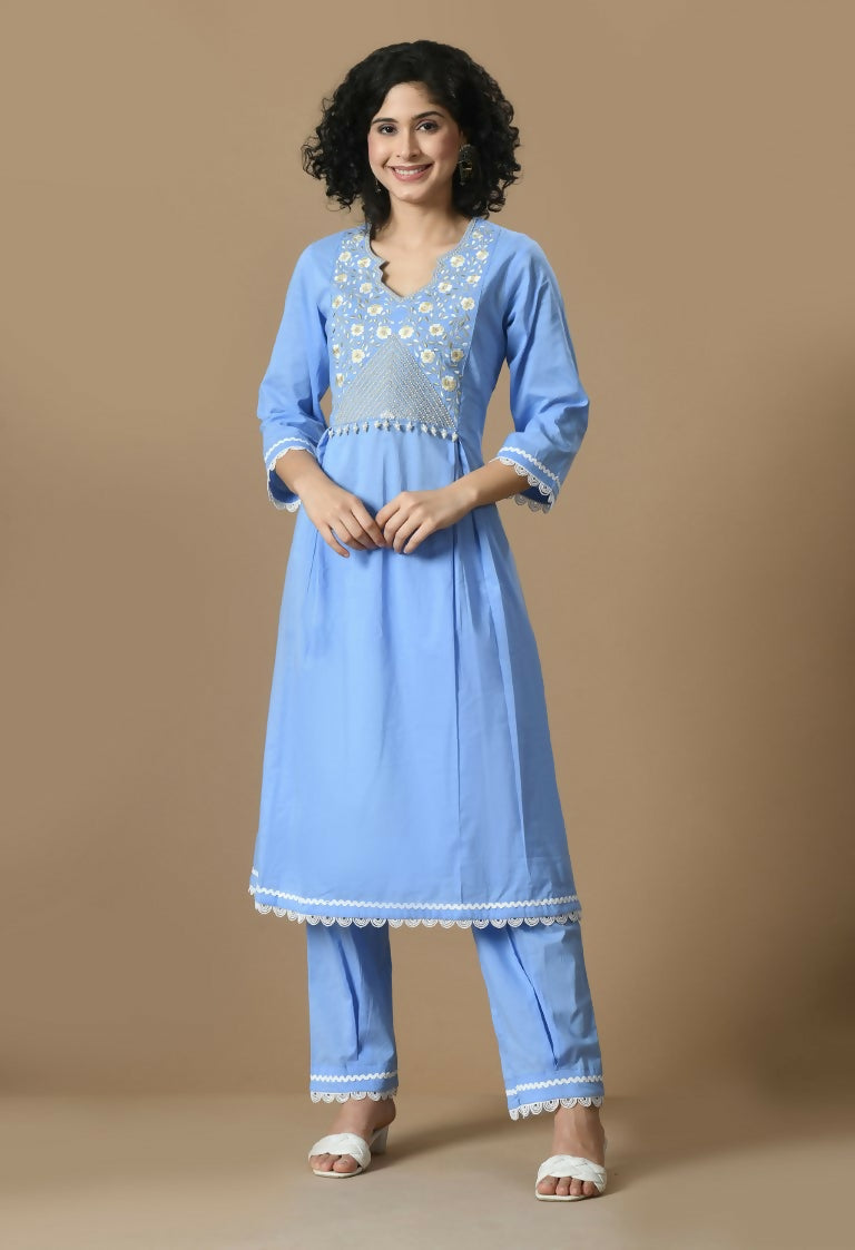 A light blue cotton kurta set featuring matching bottoms and a sheer organza dupatta.