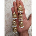 Bridal gold-polished jhumka earrings with white pearl dangles