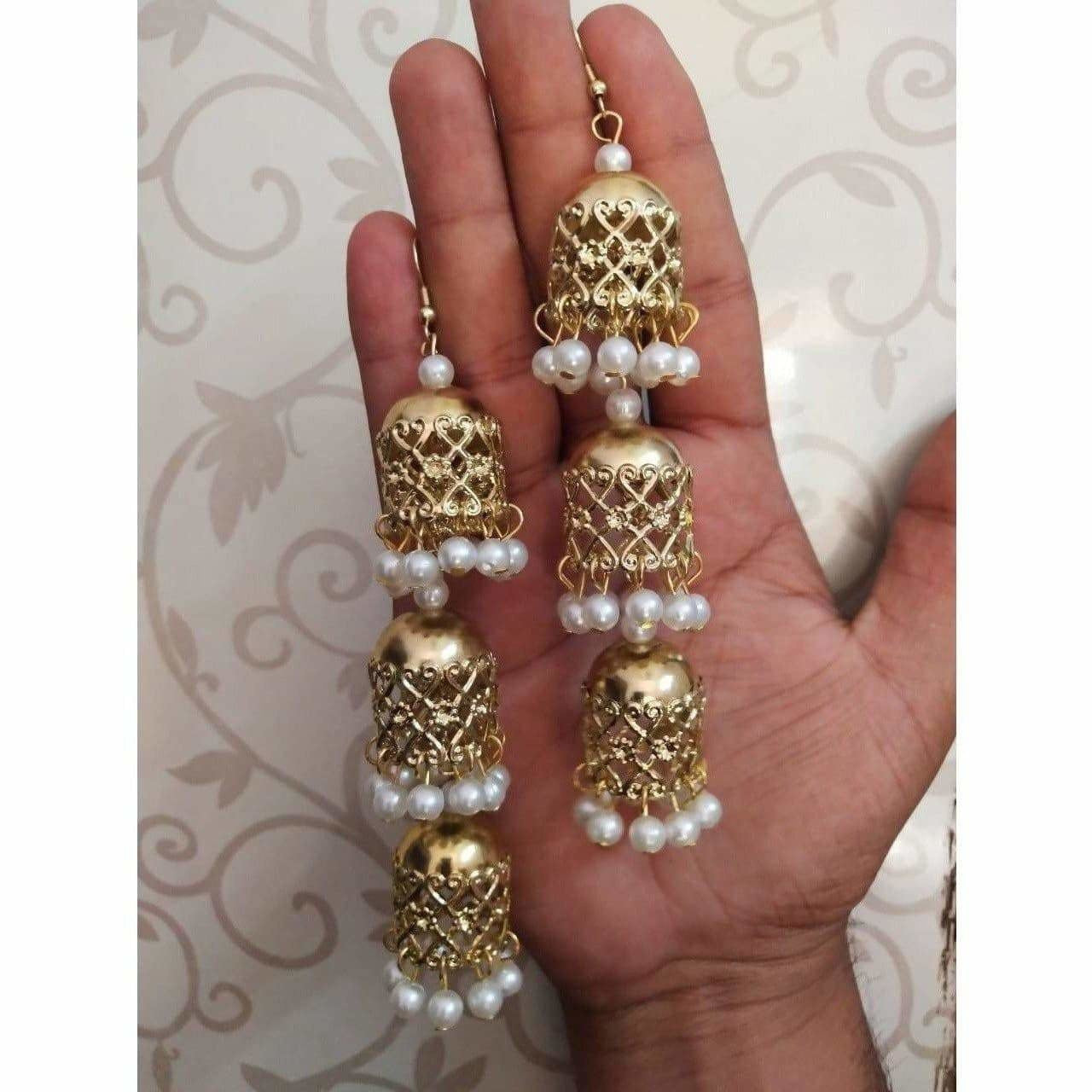 Bridal gold-polished jhumka earrings with white pearl dangles
